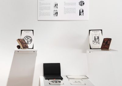 "Formidable Fragments" exhibition detail, logo stamping station, souvenir postcards with custom rubber stamps, installed at the Berkeley Art Center, 2016 by Kathy Aoki